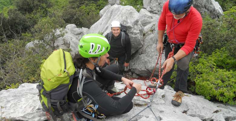 preparazione di una sosta, durante il corso di manovre e sicurezza in arrampicata su roccia
